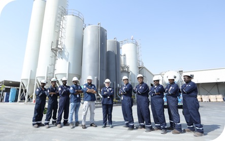 The Superior Cementing team standing outside of its Kuwait facilty posing together with their arms crossed