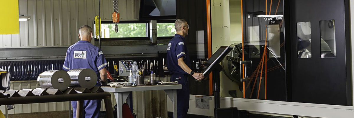 Quail Tool engineerings reviewing BOP stack parts in warehouse
